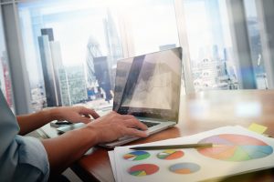 business documents on office table with smart phone and laptop